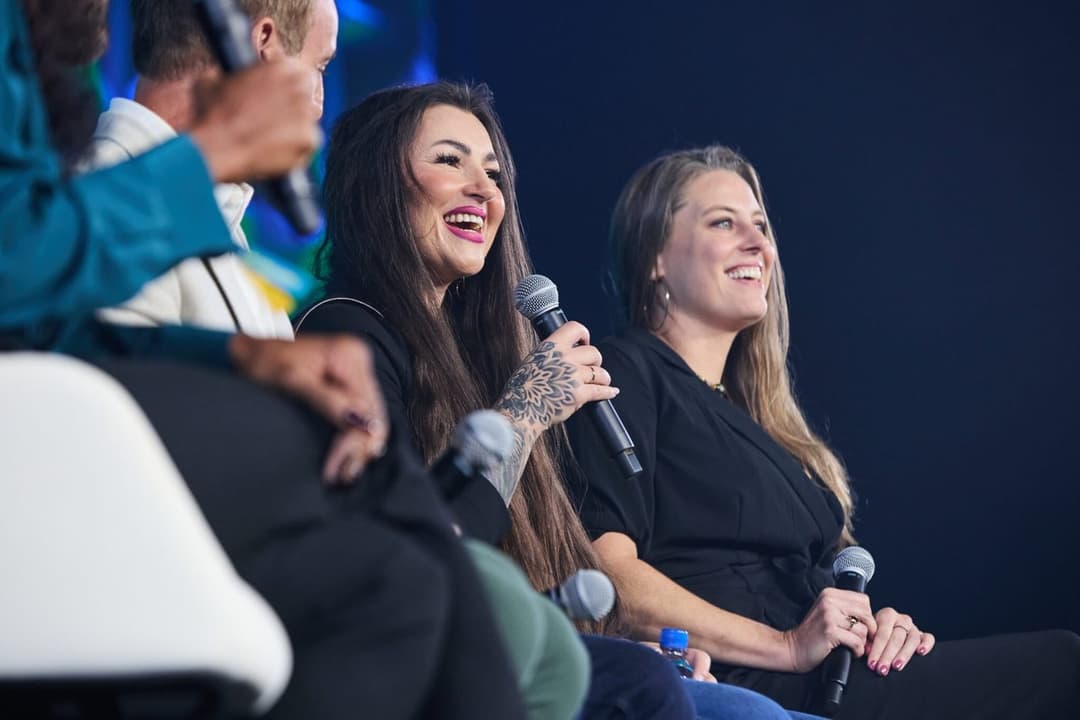 Breanna on the GoHighLevel LevelUp 2025 panel, microphone in hand