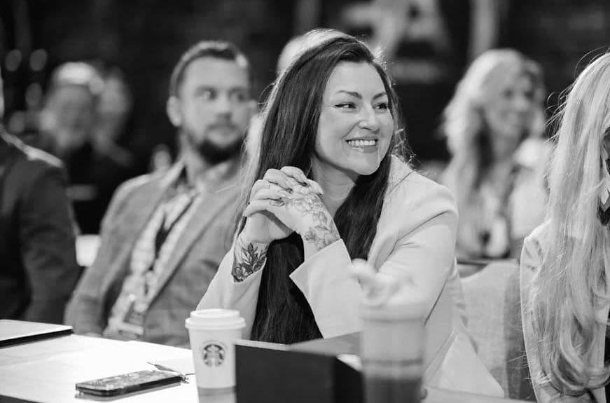 Breanna smiling at a GoHighLevel event, black and white